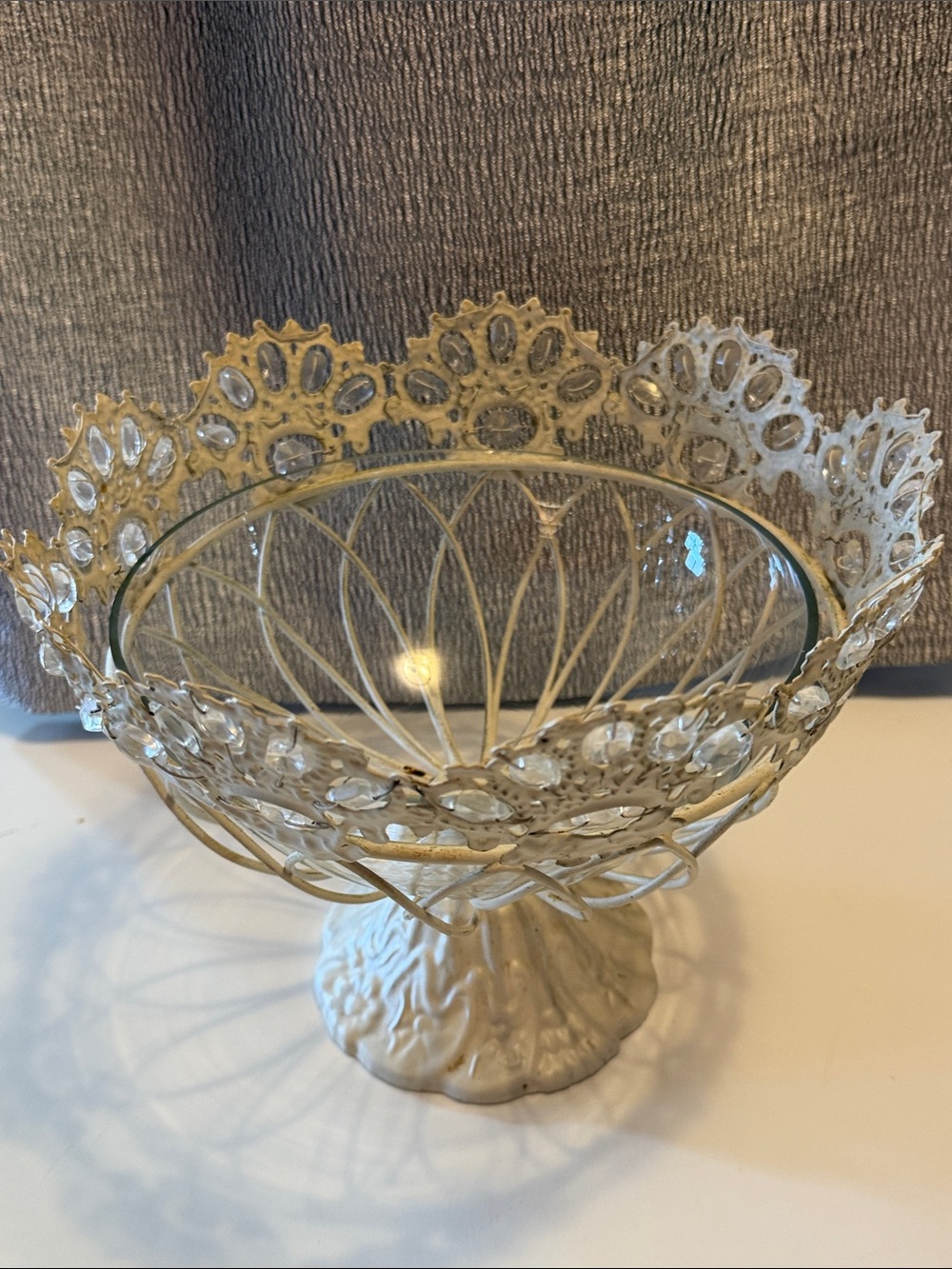 Filigree metal fruit bowl on stand with glass bowl insert. Farmhouse style.